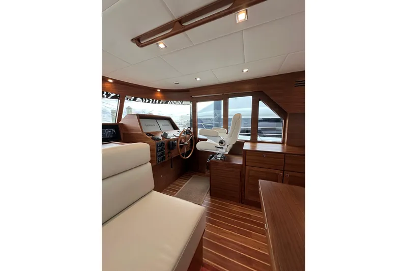 Slide: The Image of Luxurious interior of 2026 Summit 54 yacht with wooden finishes and modern helm. - 12