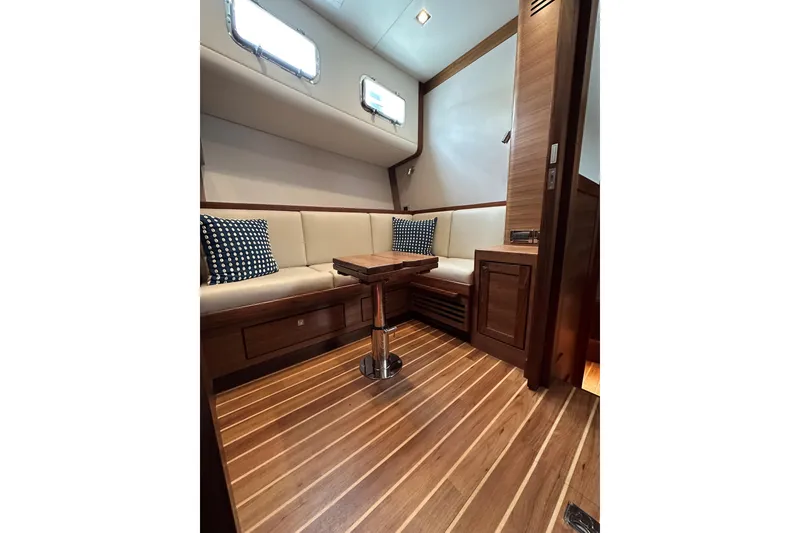 Slide: The Image of Luxurious interior of 2026 Summit 54 yacht with wood flooring and cushioned seating. - 14