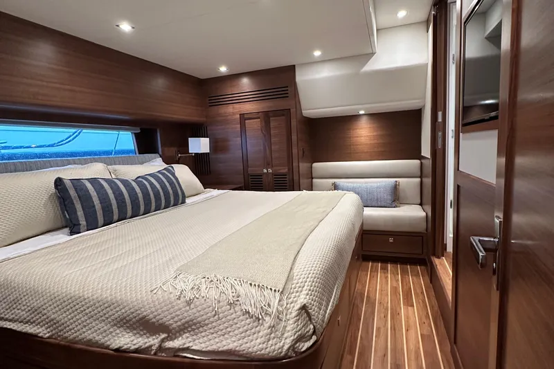 Slide: The Image of Luxurious cabin interior of 2026 Summit 54 yacht with elegant wood finishes and cozy bedding. - 18