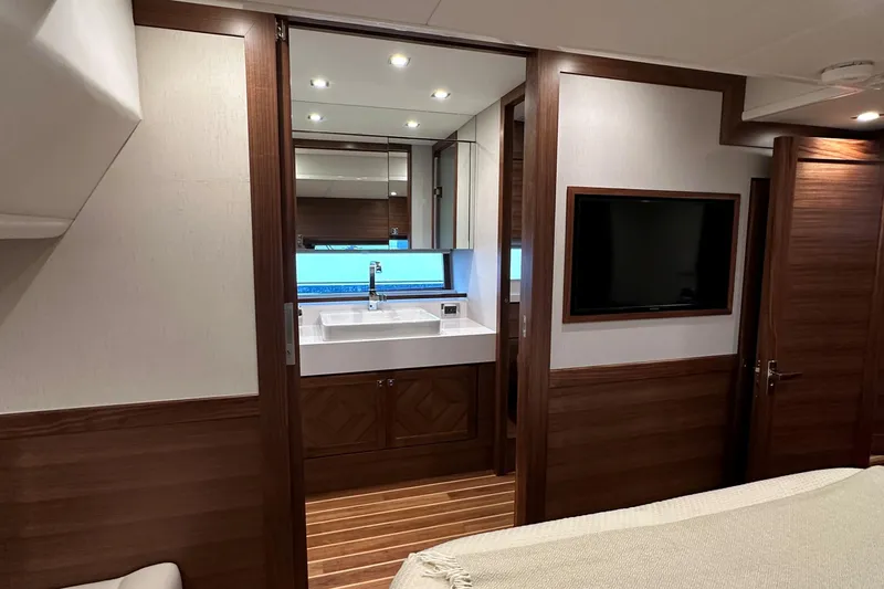 Slide: The Image of Luxurious interior of 2026 Summit 54 yacht featuring modern bathroom and sleek wood finishes. - 19