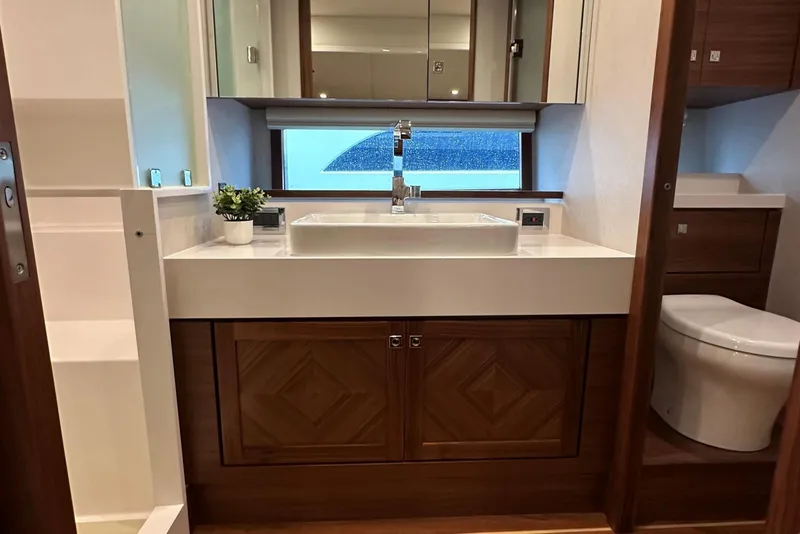 Slide: The Image of Modern bathroom in 2026 Summit 54 yacht with sleek sink, wooden cabinetry, and potted plant. - 20
