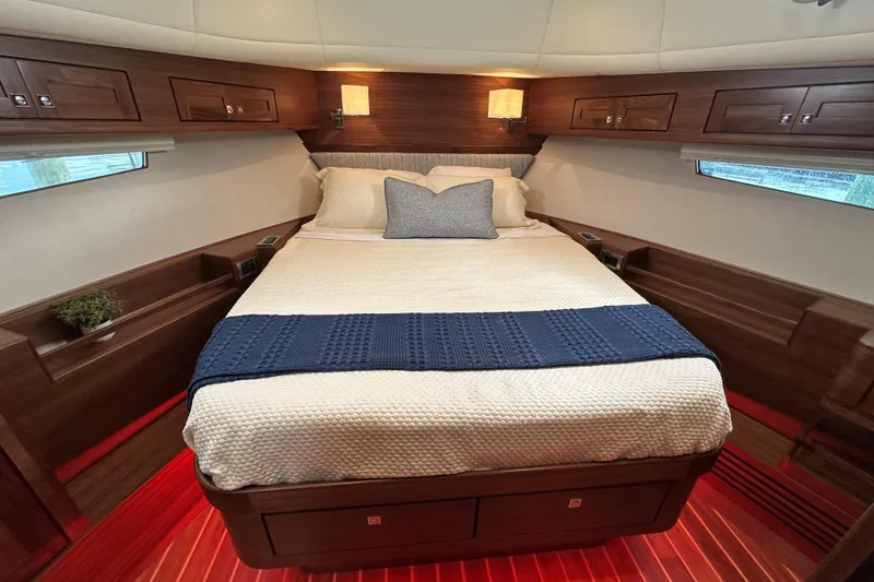 Slide: The Image of Luxurious cabin interior of 2026 Summit 54 yacht with cozy bed and elegant wood finish. - 22