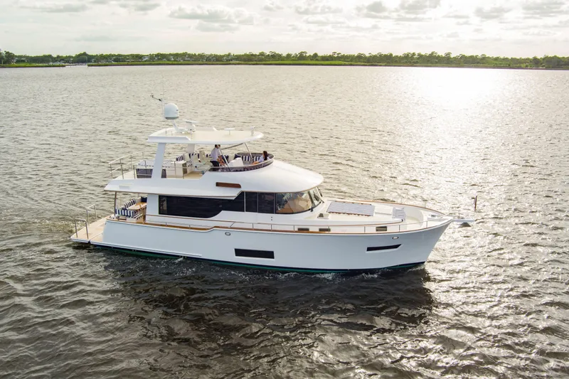 Slide: The Image of Luxurious 2026 Summit 54 yacht with striped seating, docked at marina under blue sky. - 29