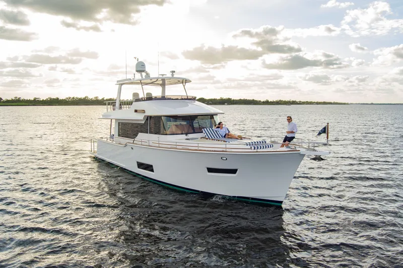 Slide: The Image of Luxurious 2026 Summit 54 yacht with striped seating and elegant bar stools on deck. - 3