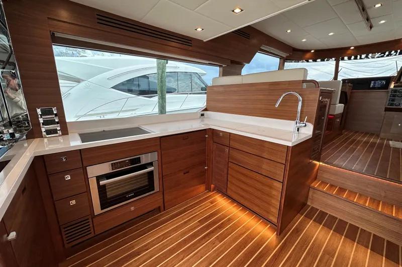 Slide: The Image of Luxurious 2026 Summit 54 yacht interior with modern kitchen and sleek wood finishes. - 6