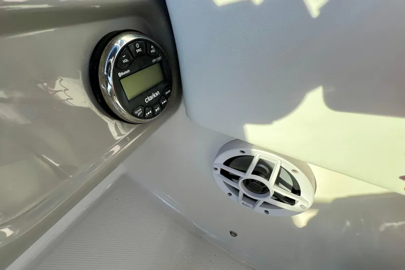 Slide: The Image of 2024 Robalo R207 Dual Console boat with Clarion audio system and speaker. - 14