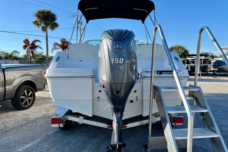 Slide: The Image of 2024 Robalo R207 Dual Console boat with Yamaha 150 engine, parked on trailer. - 4
