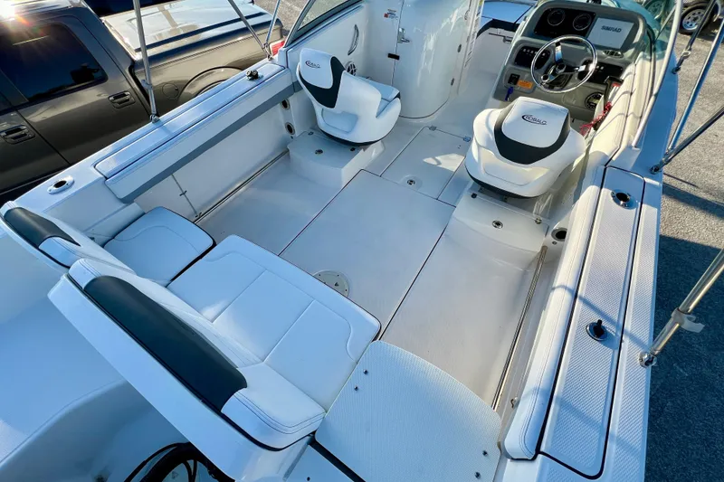 Slide: The Image of 2024 Robalo R207 Dual Console boat interior with seating and steering wheel. - 7