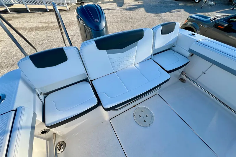 Slide: The Image of 2024 Robalo R207 Dual Console boat seating area with white and black upholstery. - 8