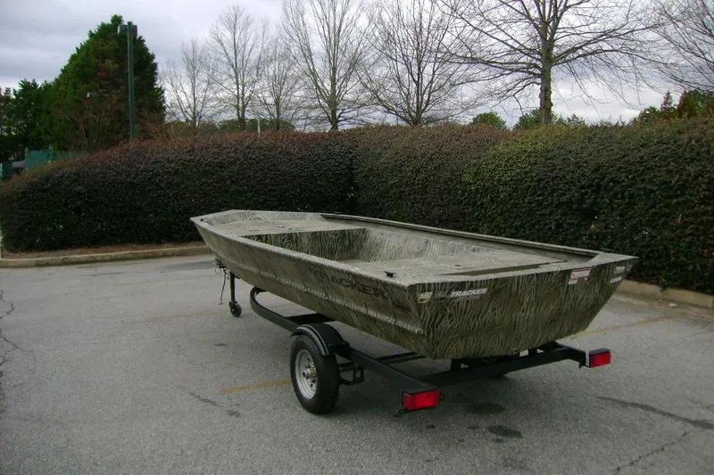 Slide: The Image of 2026 Tracker Grizzly 1648 Utility boat on trailer in parking lot. - 2
