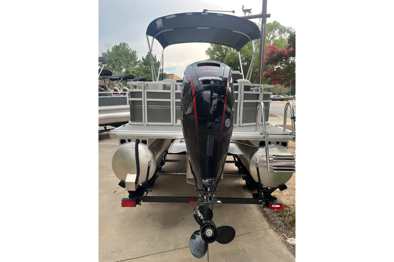 Slide: The Image of 2026 Sun Tracker Fishin' Barge 22 DLX pontoon boat with outboard motor, rear view. - 1