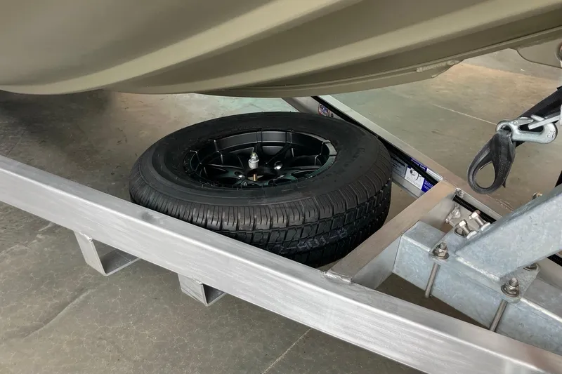 Slide: The Image of 2026 Tracker Grizzly 1650 T Prairie Wings Edition trailer with spare tire. - 9