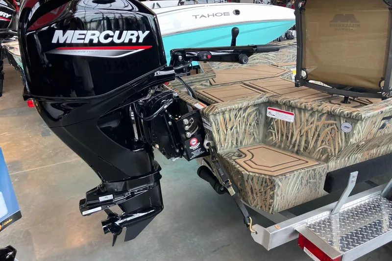 Slide: The Image of 2026 Tracker Grizzly 1650 T Prairie Wings Edition with Mercury outboard motor, camo design. - 6