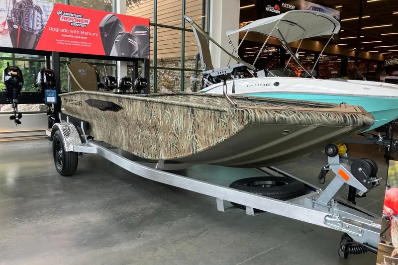 The Image of 2026 Tracker Grizzly 1650 T Prairie Wings Edition boat on display in showroom. - 0