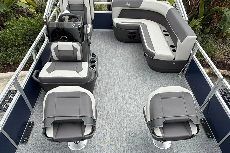 Slide: The Image of 2026 Sun Tracker Bass Buggy 16 XL Select pontoon boat with seating and helm, docked outdoors. - 4