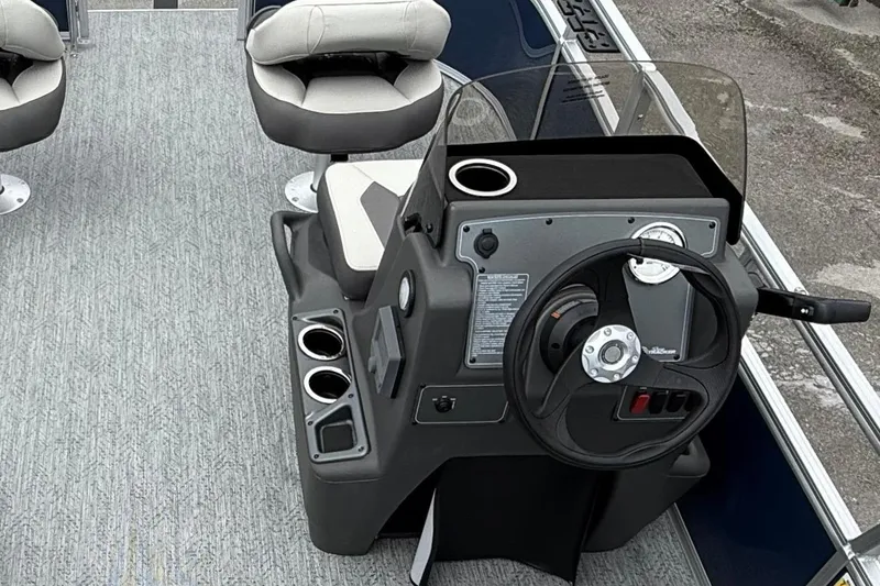 Slide: The Image of 2026 Sun Tracker Bass Buggy 16 XL Select pontoon boat interior with seating and steering console. - 3