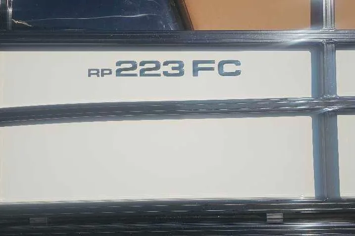 Slide: The Image of 2026 Ranger 223FC boat model nameplate on a sleek exterior. - 2