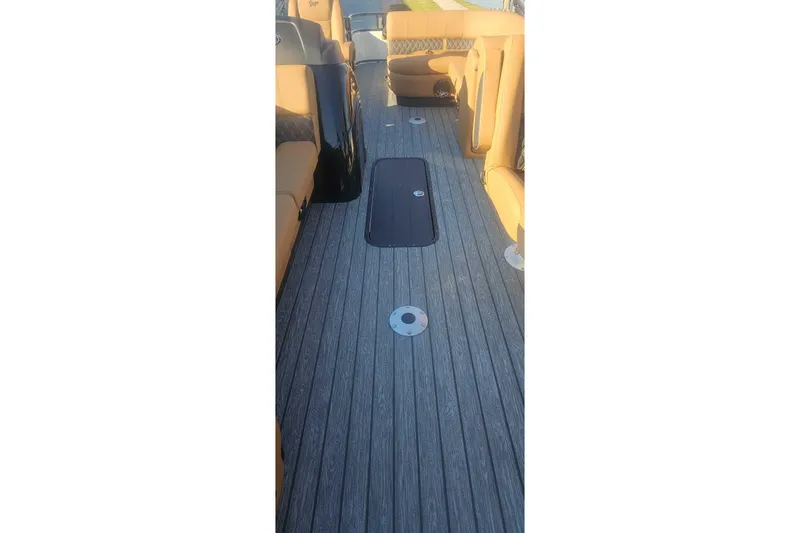 Slide: The Image of Interior view of 2026 Ranger 223FC boat with wood-textured flooring and tan seating. - 4