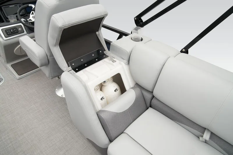 Slide: The Image of 2026 Regency 230 DL boat interior with open storage compartment and plush seating. - 8