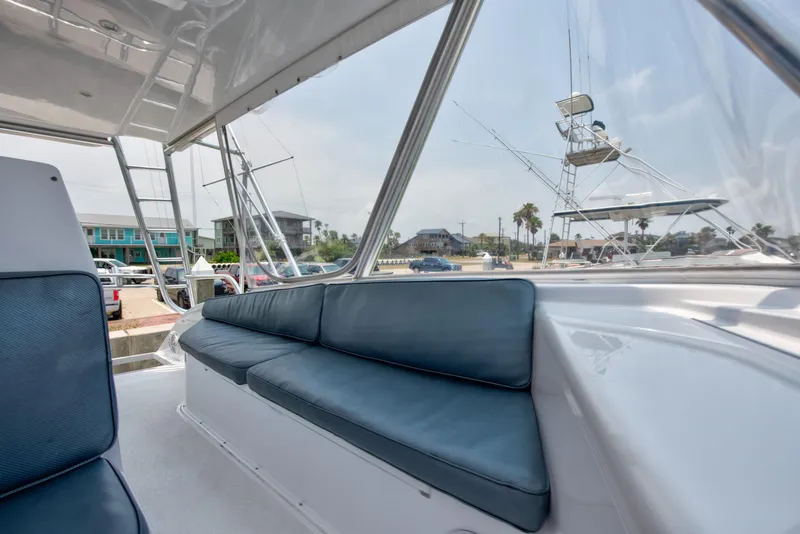 Slide: The Image of 2001 Viking 55 Convertible yacht interior with blue cushioned seating. - 10