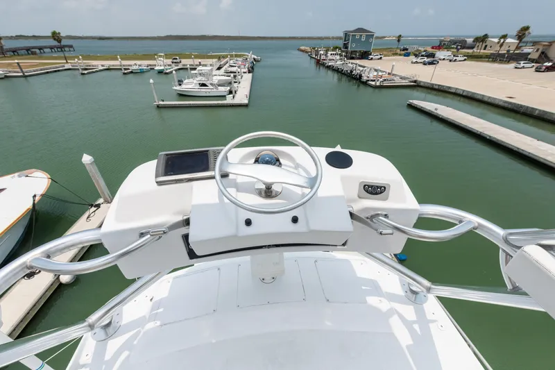 Slide: The Image of View from the helm of a 2001 Viking 55 Convertible yacht in a marina. - 12