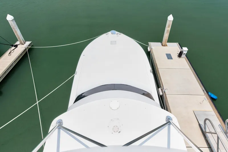 Slide: The Image of Top view of a 2001 Viking 55 Convertible yacht docked at a marina. - 13