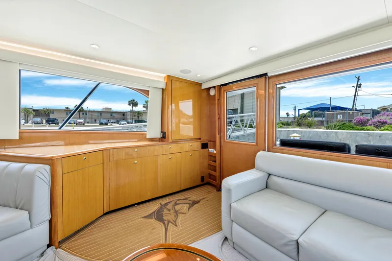 Slide: The Image of Interior of 2001 Viking 55 Convertible yacht with light wood cabinetry and white seating. - 18