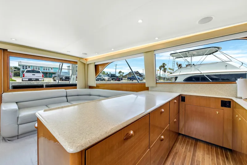 Slide: The Image of Interior of 2001 Viking 55 Convertible yacht with spacious seating and modern kitchen. - 20
