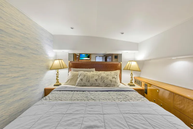 Slide: The Image of Luxurious bedroom interior of 2001 Viking 55 Convertible yacht with cozy bedding. - 22
