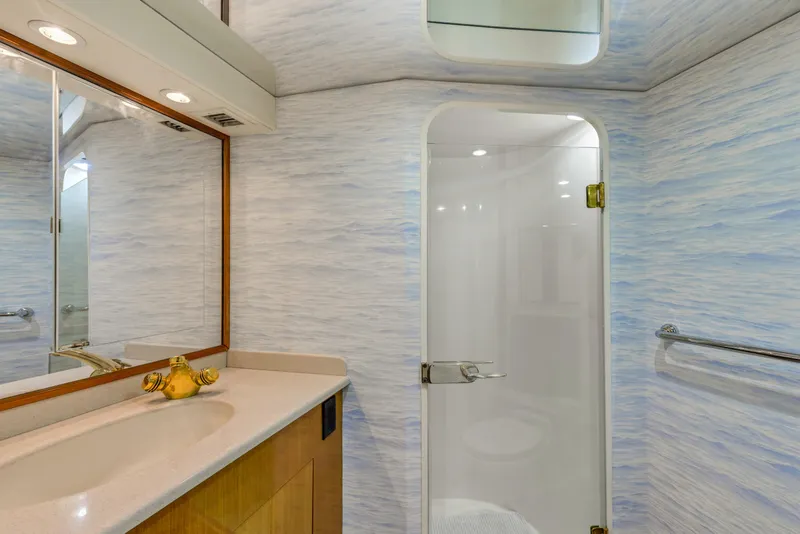 Slide: The Image of 2001 Viking 55 Convertible yacht bathroom with shower, vanity, and mirror. - 25