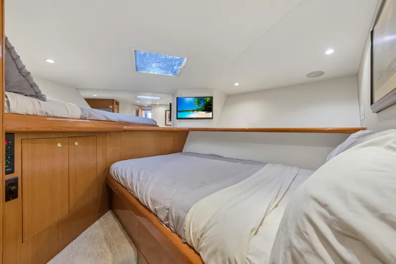 Slide: The Image of 2001 Viking 55 Convertible yacht cabin with twin beds and TV. - 27