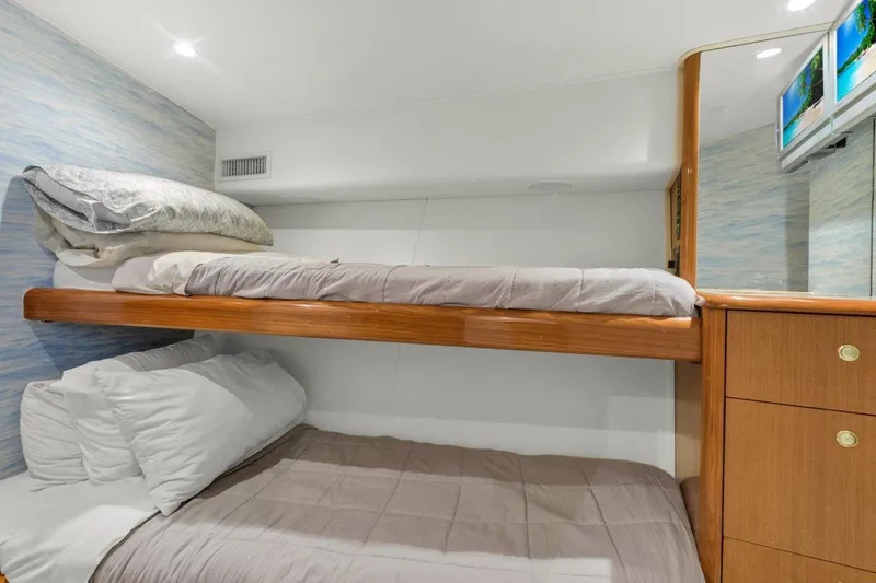 Slide: The Image of Bunk beds in the 2001 Viking 55 Convertible yacht cabin with wooden accents. - 30