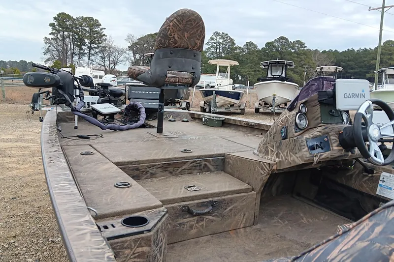 Slide: The Image of 2018 G3 Sportsman 17 Camo boat with Garmin and Humminbird electronics, parked outdoors. - 10