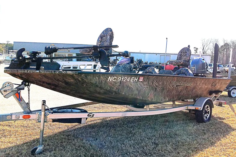 Slide: The Image of 2018 G3 Sportsman 17 Camo boat on trailer, featuring camouflage design and outboard motor. - 6