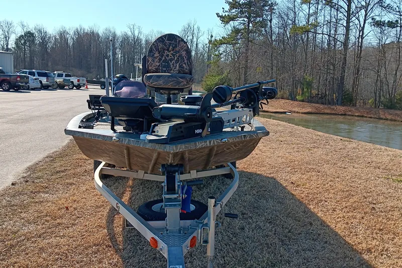 Slide: The Image of 2018 G3 Sportsman 17 Camo boat on trailer near lake and parking lot. - 7