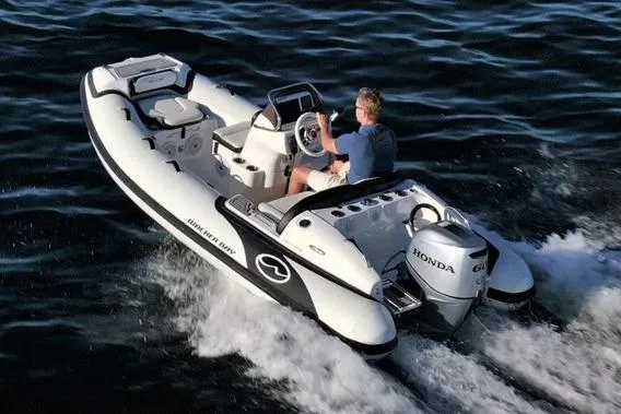 Slide: The Image of 2025 Walker Bay Venture 13 boat cruising on water with Honda engine. - 11