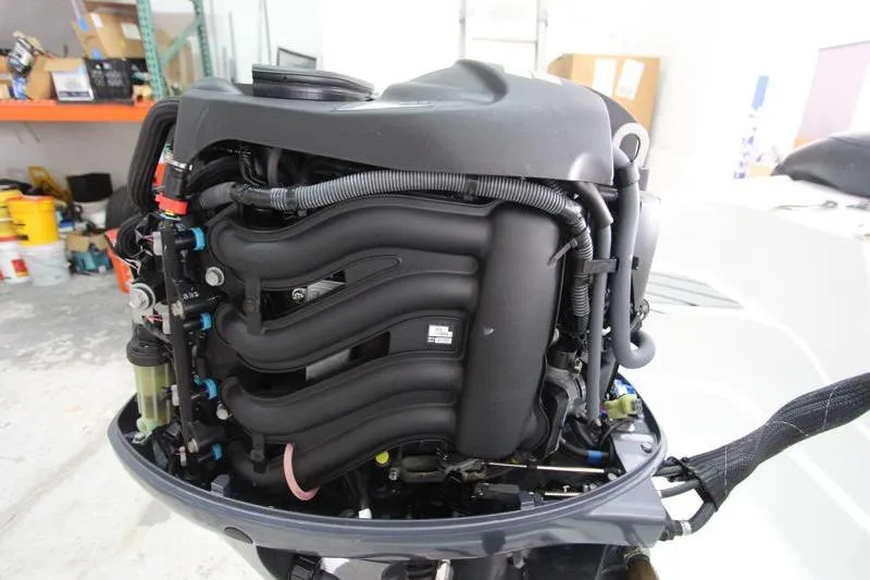 Slide: The Image of 2025 Walker Bay Venture 13 outboard engine, detailed view in workshop setting. - 12