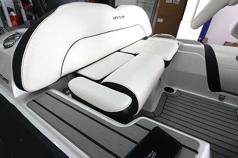 Slide: The Image of 2025 Walker Bay Venture 13 boat interior with white cushioned seating and sleek design. - 15