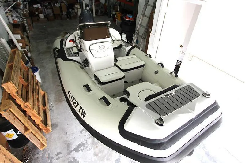 Slide: The Image of 2025 Walker Bay Venture 13 inflatable boat in a garage setting. - 19