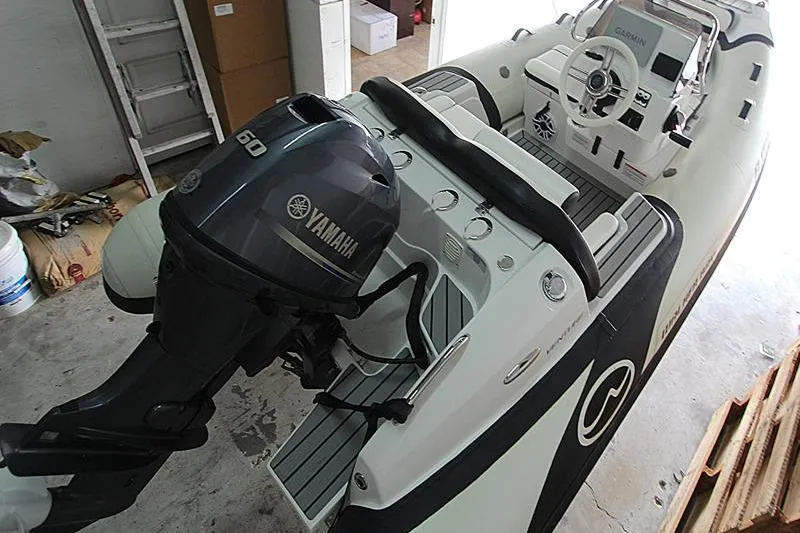 Slide: The Image of 2025 Walker Bay Venture 13 boat with Yamaha 60 engine in a garage. - 20