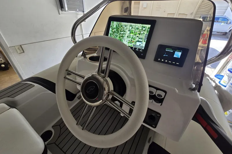 Slide: The Image of Steering console of 2025 Walker Bay Venture 13 with navigation display and controls. - 9