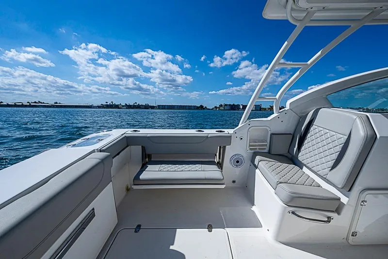 Slide: The Image of 2022 Pursuit DC 266 Dual Console boat interior with ocean view and blue sky. - 11