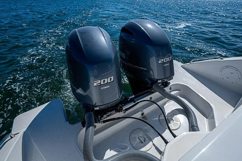 Slide: The Image of 2022 Pursuit DC 266 Dual Console with twin Yamaha 200 engines on open water. - 16