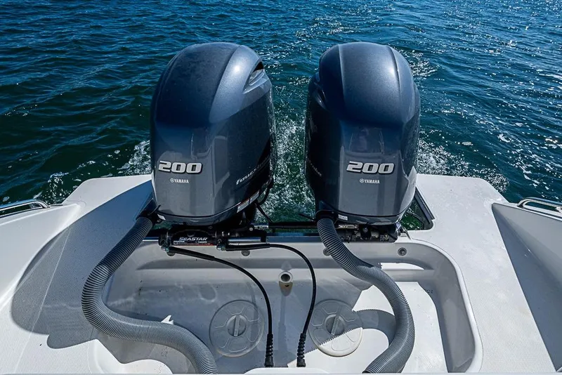 Slide: The Image of 2022 Pursuit DC 266 Dual Console with twin Yamaha 200 engines on open water. - 17