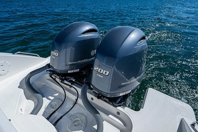 Slide: The Image of Twin Yamaha 200 engines on 2022 Pursuit DC 266 Dual Console boat in open water. - 18