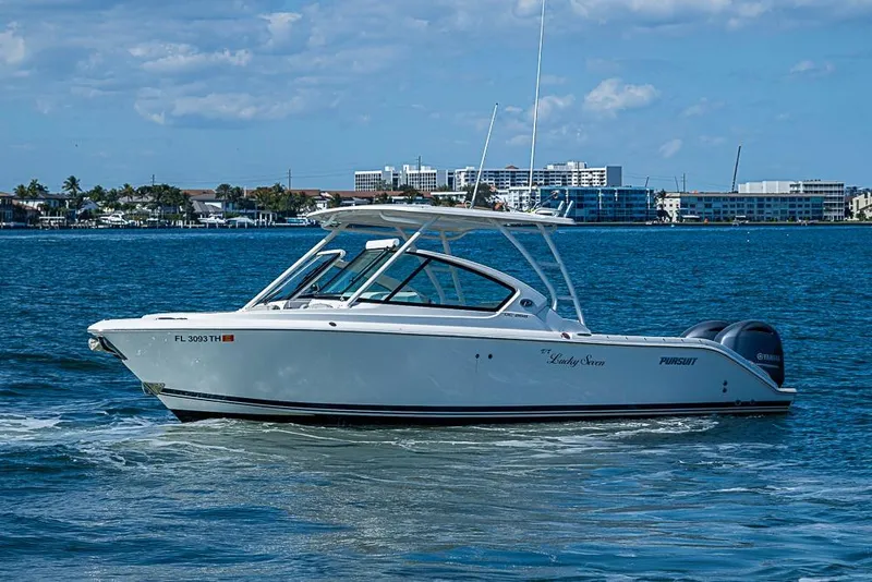 Slide: The Image of 2022 Pursuit DC 266 Dual Console boat cruising on a sunny day. - 22