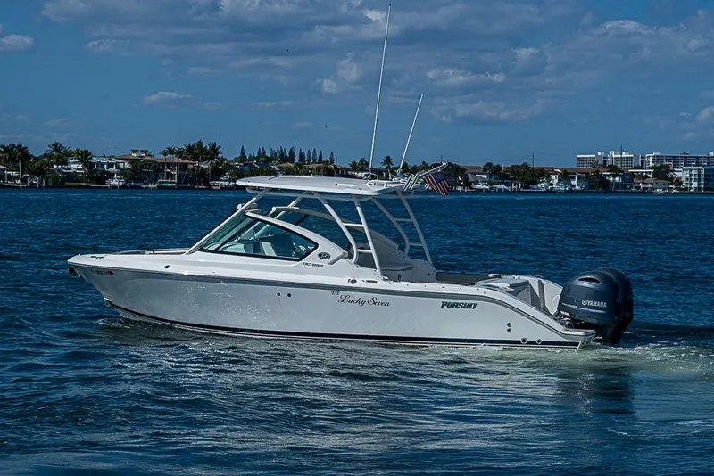 Slide: The Image of 2022 Pursuit DC 266 Dual Console boat cruising on a sunny day. - 25