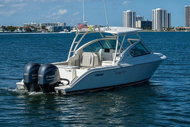 Slide: The Image of 2022 Pursuit DC 266 Dual Console boat on water with twin Yamaha engines. - 29