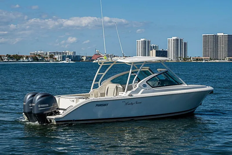 Slide: The Image of 2022 Pursuit DC 266 Dual Console boat on water with city skyline background. - 30