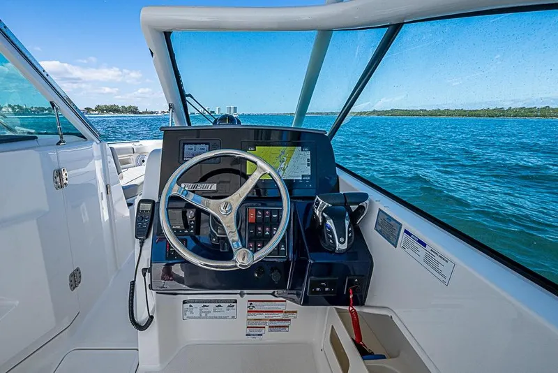 Slide: The Image of 2022 Pursuit DC 266 Dual Console boat dashboard with ocean view. - 33